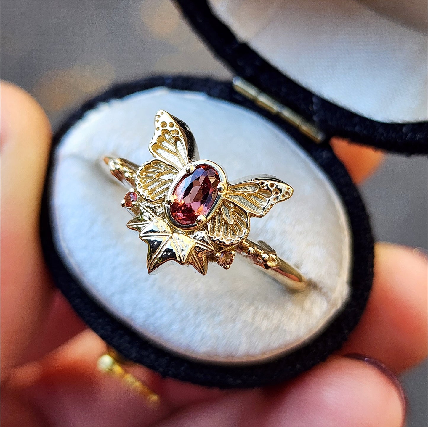 rose champagne oval garnet butterfly ring with 3 ivy leaves and orange sapphires 