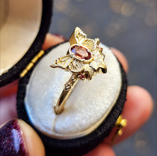 rose champagne oval garnet butterfly ring with 3 ivy leaves and orange sapphires 