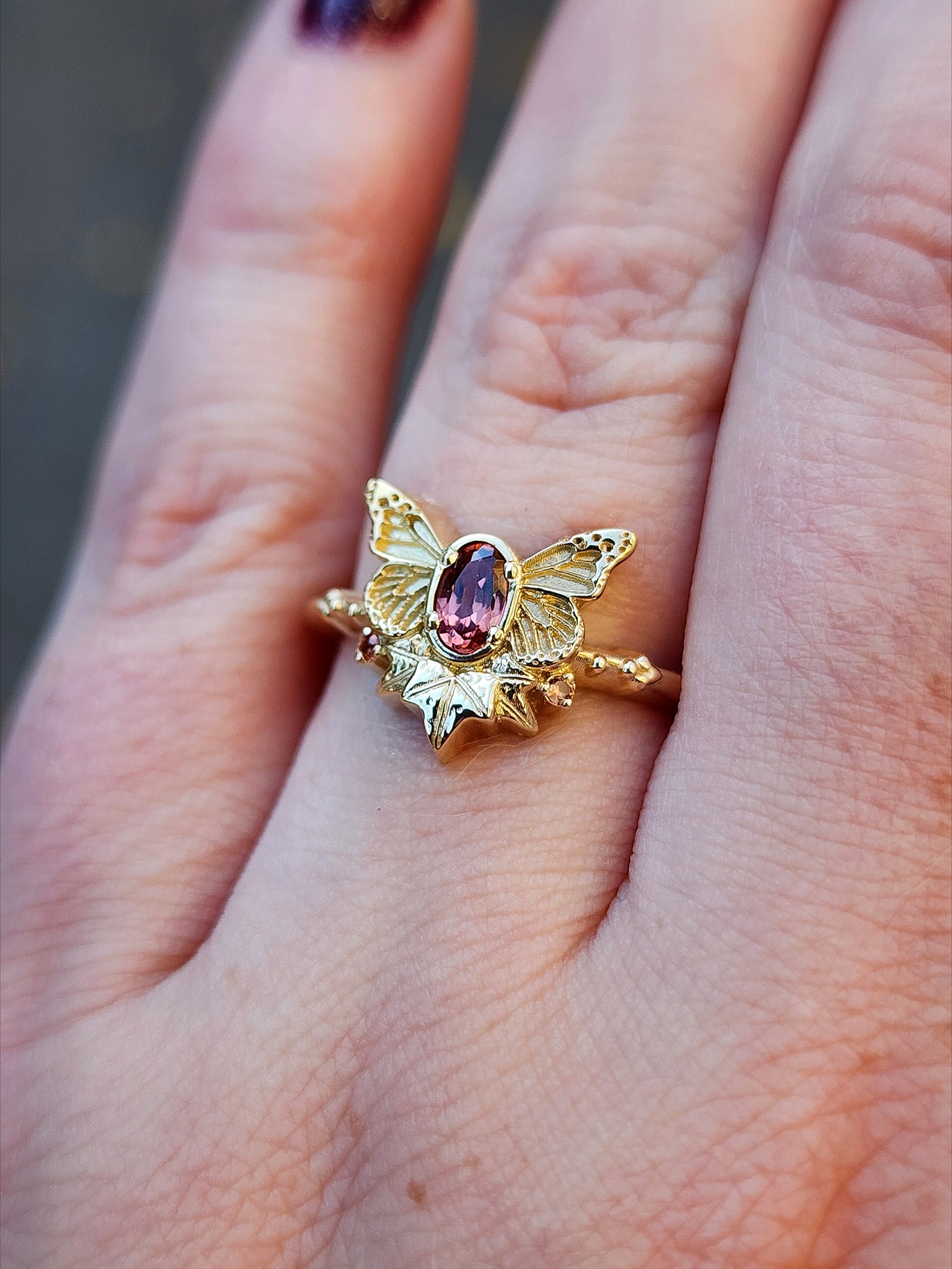 rose champagne oval garnet butterfly ring with 3 ivy leaves and orange sapphires 