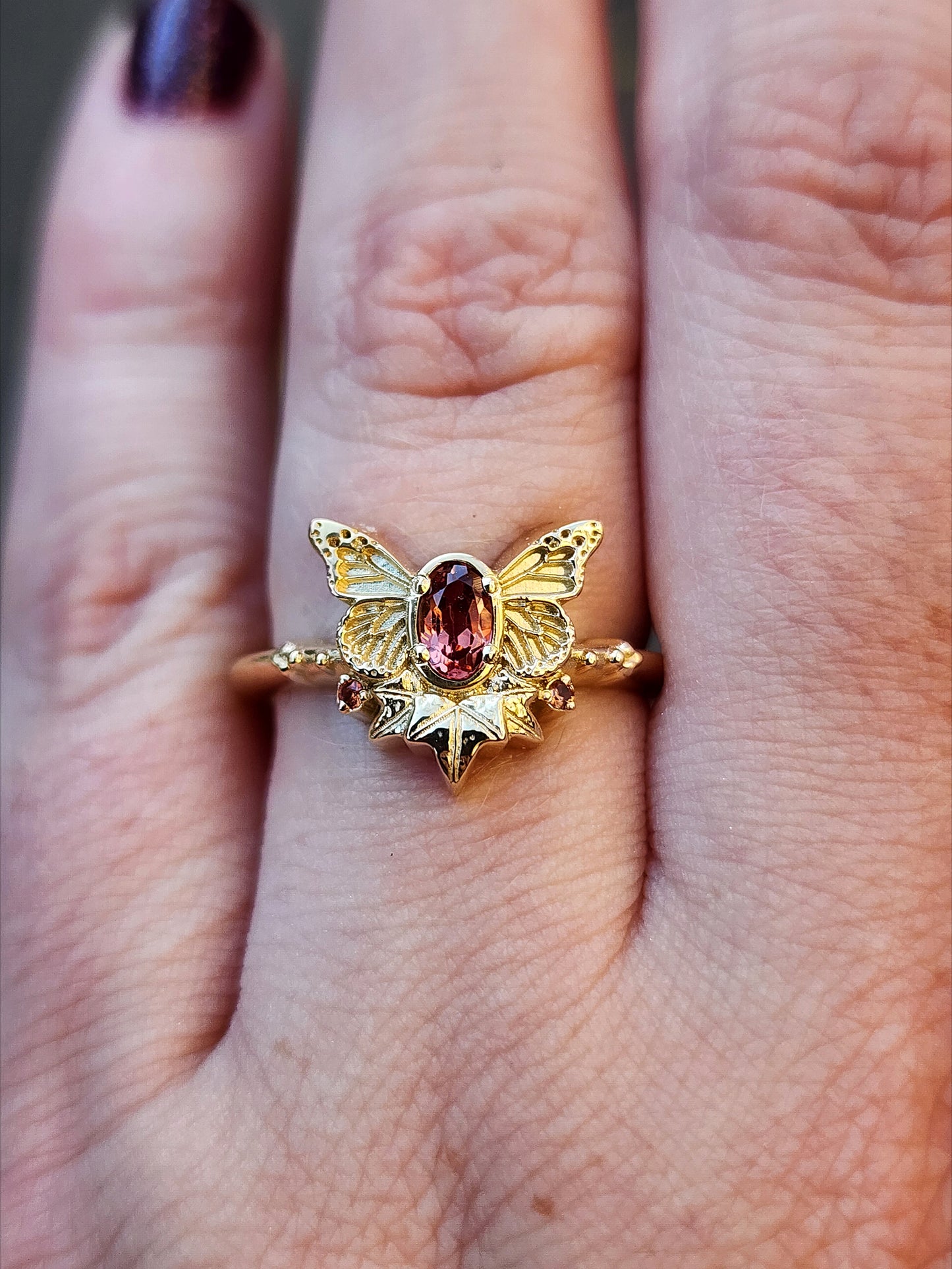 rose champagne oval garnet butterfly ring with 3 ivy leaves and orange sapphires 