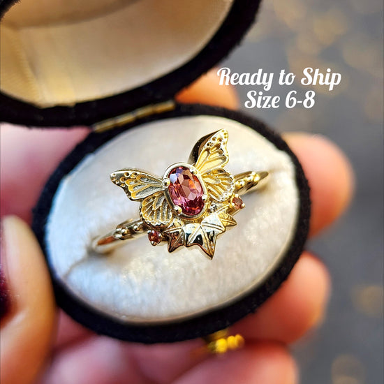 rose champagne oval garnet butterfly ring with 3 ivy leaves and orange sapphires 