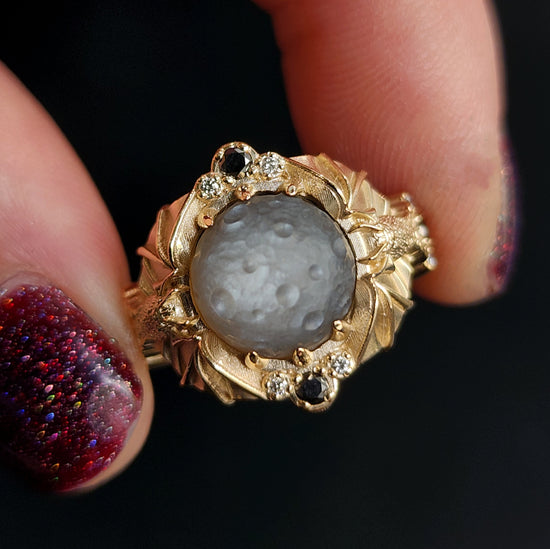 Keeper of the Moon ring by SwankMetalsmithing with hand carved gray moonstone moon and gold vampire bats