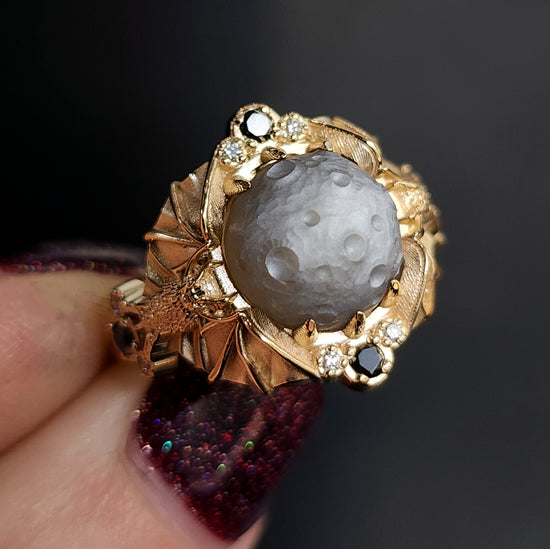 Keeper of the Moon ring by SwankMetalsmithing with hand carved gray moonstone moon and gold vampire bats