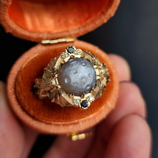 Keeper of the Moon ring by SwankMetalsmithing with hand carved gray moonstone moon and gold vampire bats