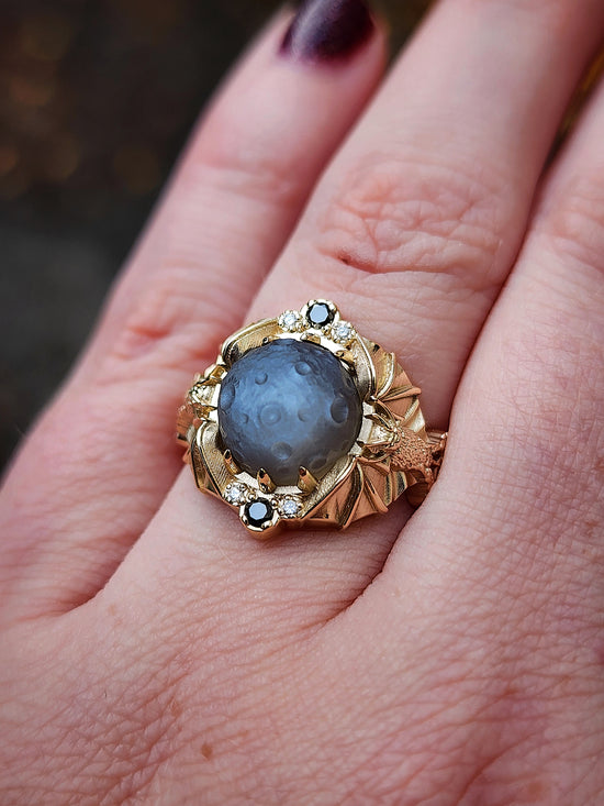 Keepers of the Moon ring by SwankMetalsmithing with hand carved gray moonstone moon and gold vampire bats