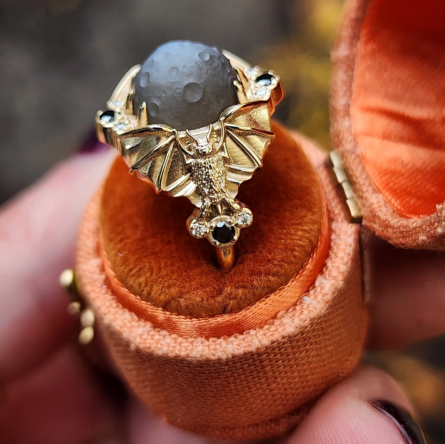 Keeper of the Moon ring by SwankMetalsmithing with hand carved gray moonstone moon and gold vampire bats