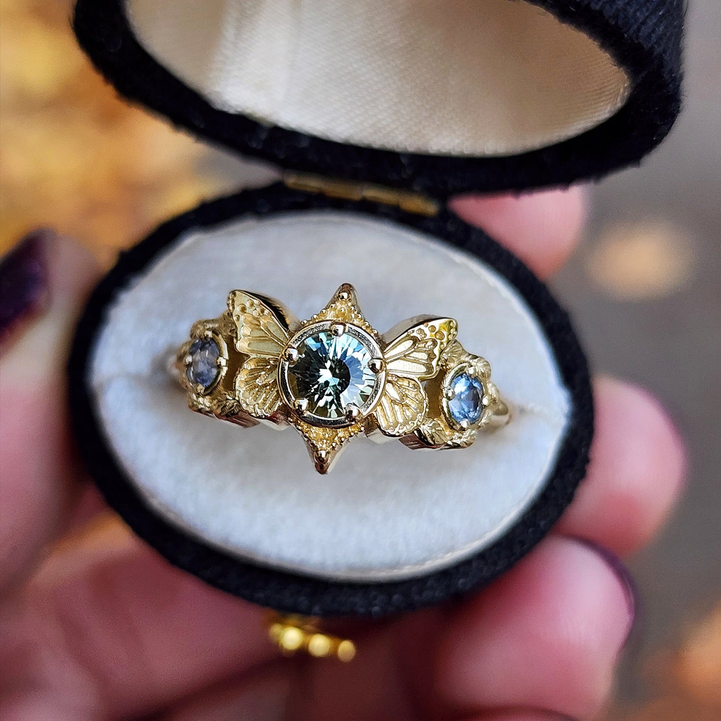 3 stone ring with Merelani mint garnet and blue sapphires with gold butterfly wings and leaves nature engagement anniversary gift