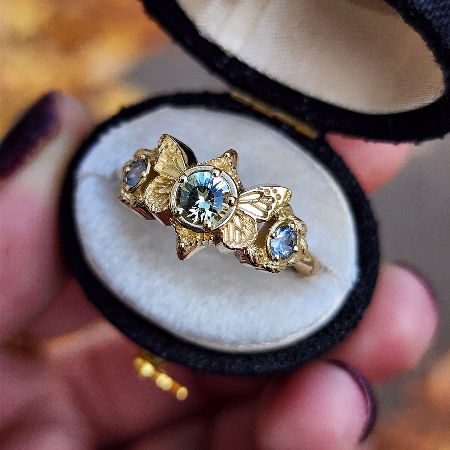 3 stone ring with Merelani mint garnet and blue sapphires with gold butterfly wings and leaves nature engagement anniversary gift