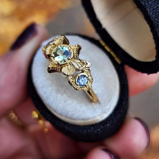 3 stone ring with Merelani mint garnet and blue sapphires with gold butterfly wings and leaves nature engagement anniversary gift