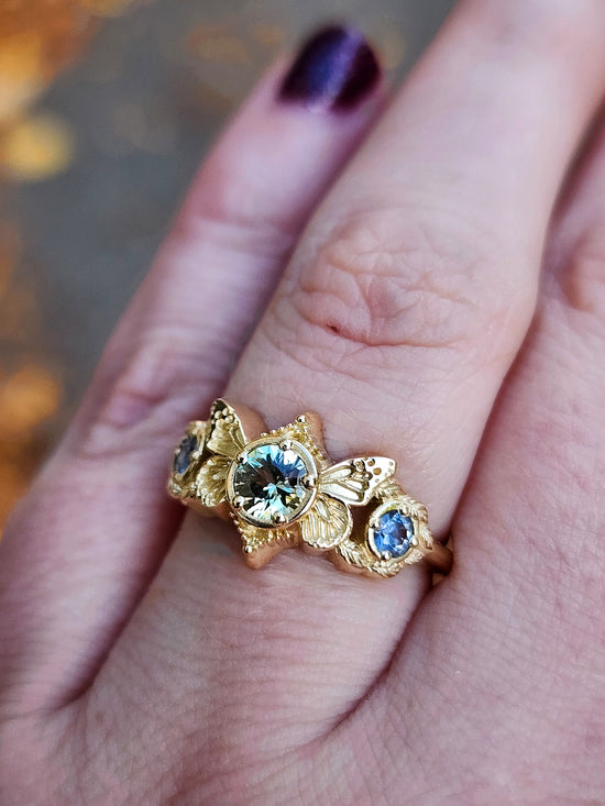 3 stone ring with Merelani mint garnet and blue sapphires with gold butterfly wings and leaves nature engagement anniversary gift