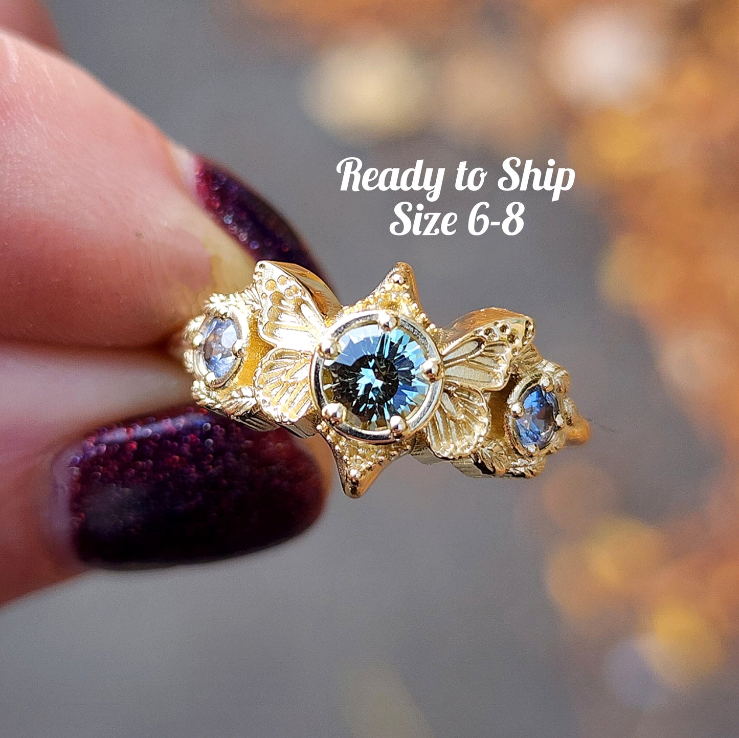 3 stone ring with Merelani mint garnet and blue sapphires with gold butterfly wings and leaves nature engagement anniversary gift