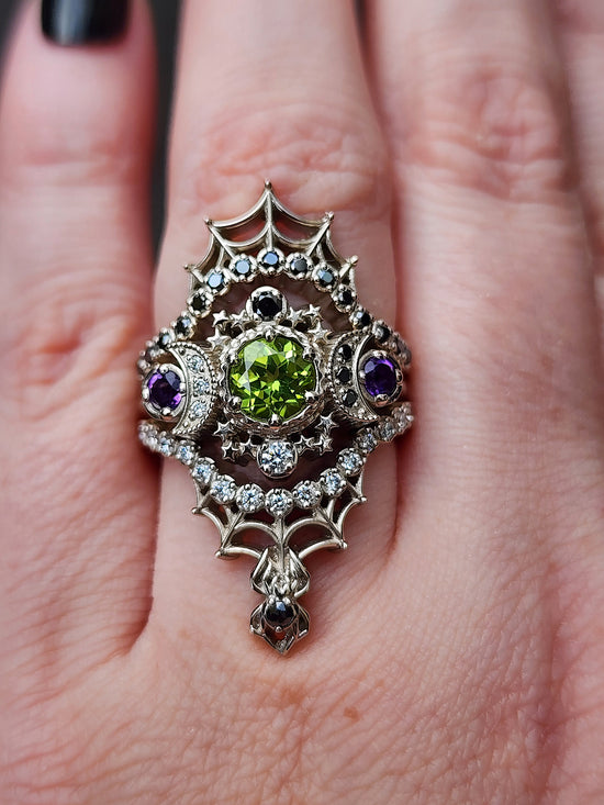 peridot and amethyst cosmos ring with black and white diamond spider web wedding bands goth pop culture wedding ring