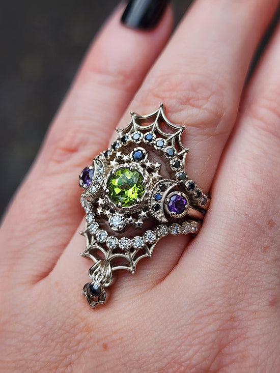 peridot and amethyst cosmos ring with black and white diamond spider web wedding bands goth pop culture wedding ring