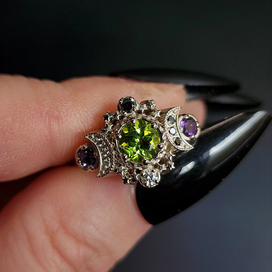 peridot and amethyst cosmos ring with black and white diamond spider web wedding bands goth pop culture wedding ring