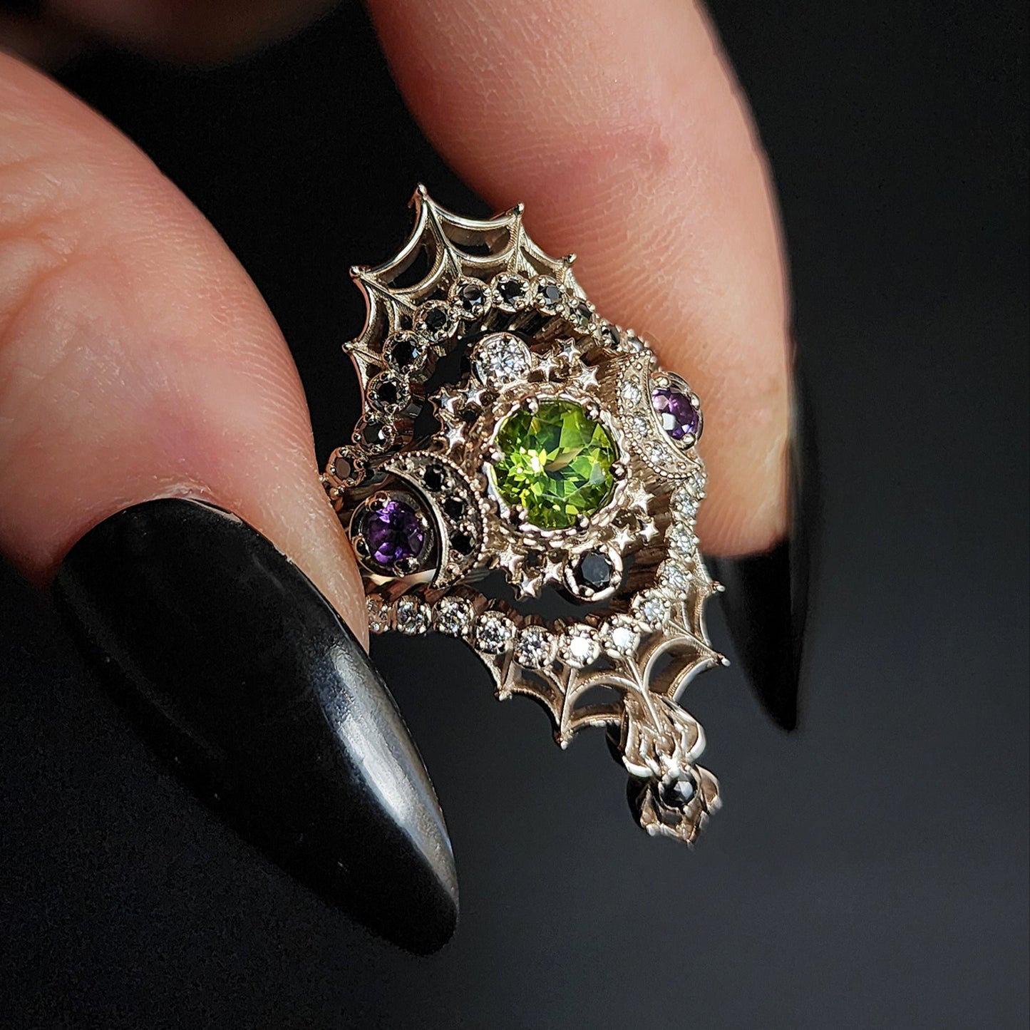 peridot and amethyst cosmos ring with black and white diamond spider web wedding bands goth pop culture wedding ring