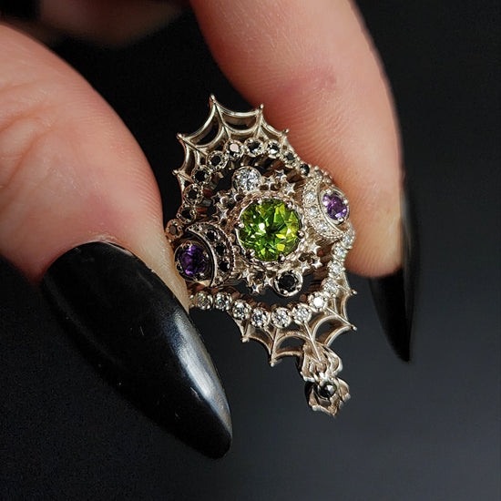 peridot and amethyst cosmos ring with black and white diamond spider web wedding bands goth pop culture wedding ring