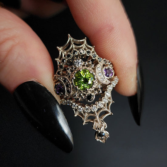 peridot and amethyst cosmos ring with black and white diamond spider web wedding bands goth pop culture wedding ring