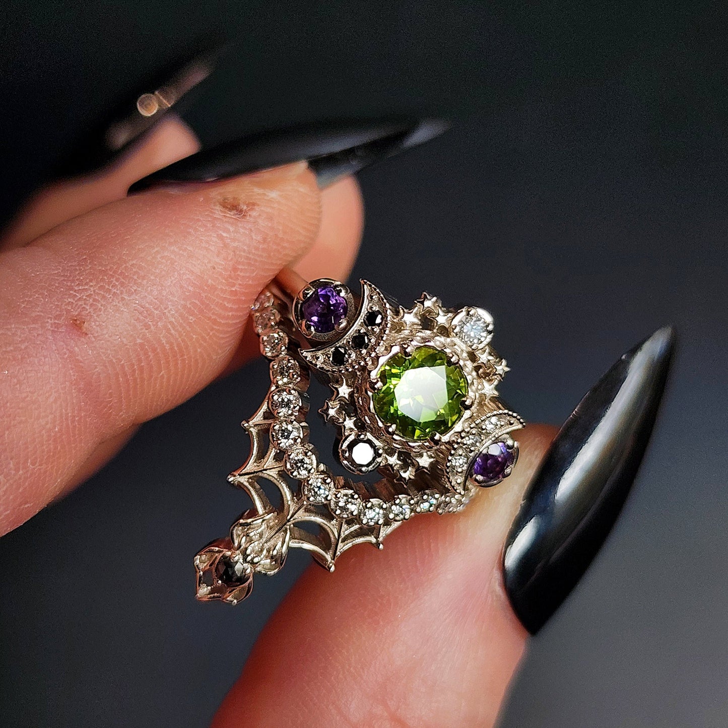 peridot and amethyst cosmos ring with black and white diamond spider web wedding bands goth pop culture wedding ring