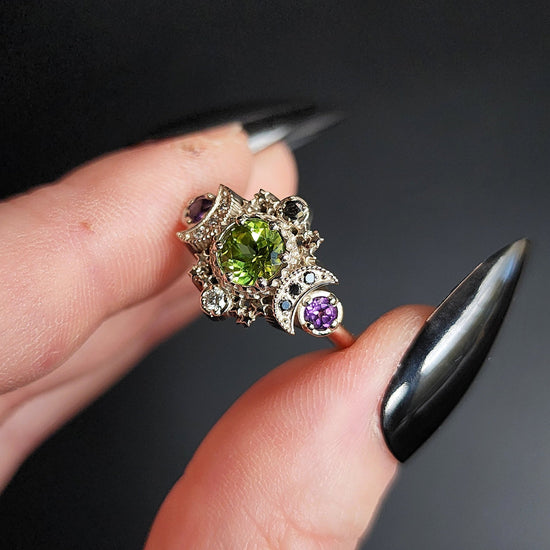 peridot and amethyst cosmos ring with black and white diamond spider web wedding bands goth pop culture wedding ring