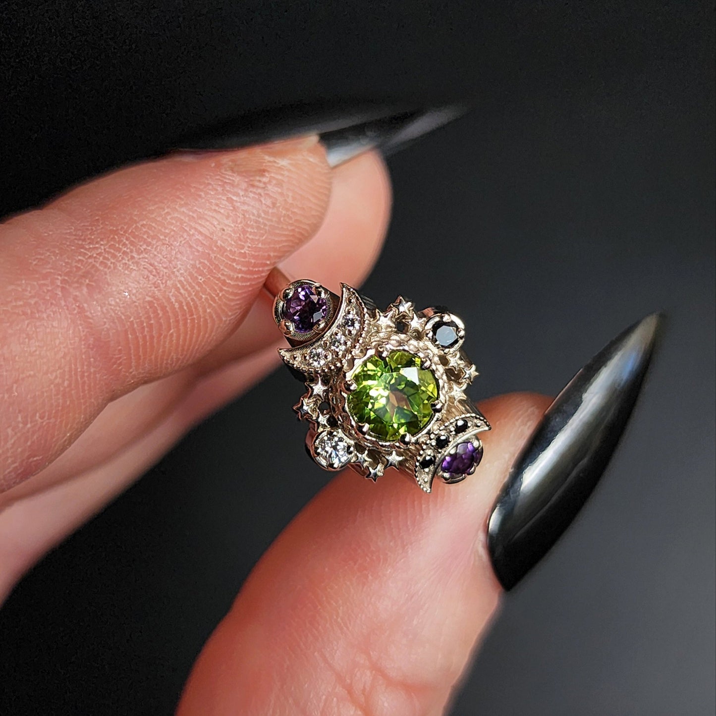 peridot and amethyst cosmos ring with black and white diamond spider web wedding bands goth pop culture wedding ring