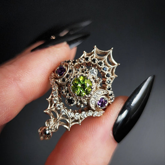 peridot and amethyst cosmos ring with black and white diamond spider web wedding bands goth pop culture wedding ring