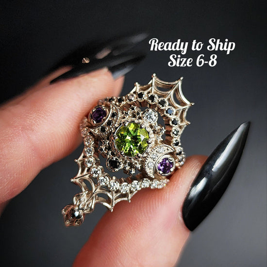 peridot and amethyst cosmos ring with black and white diamond spider web wedding bands goth pop culture wedding ring