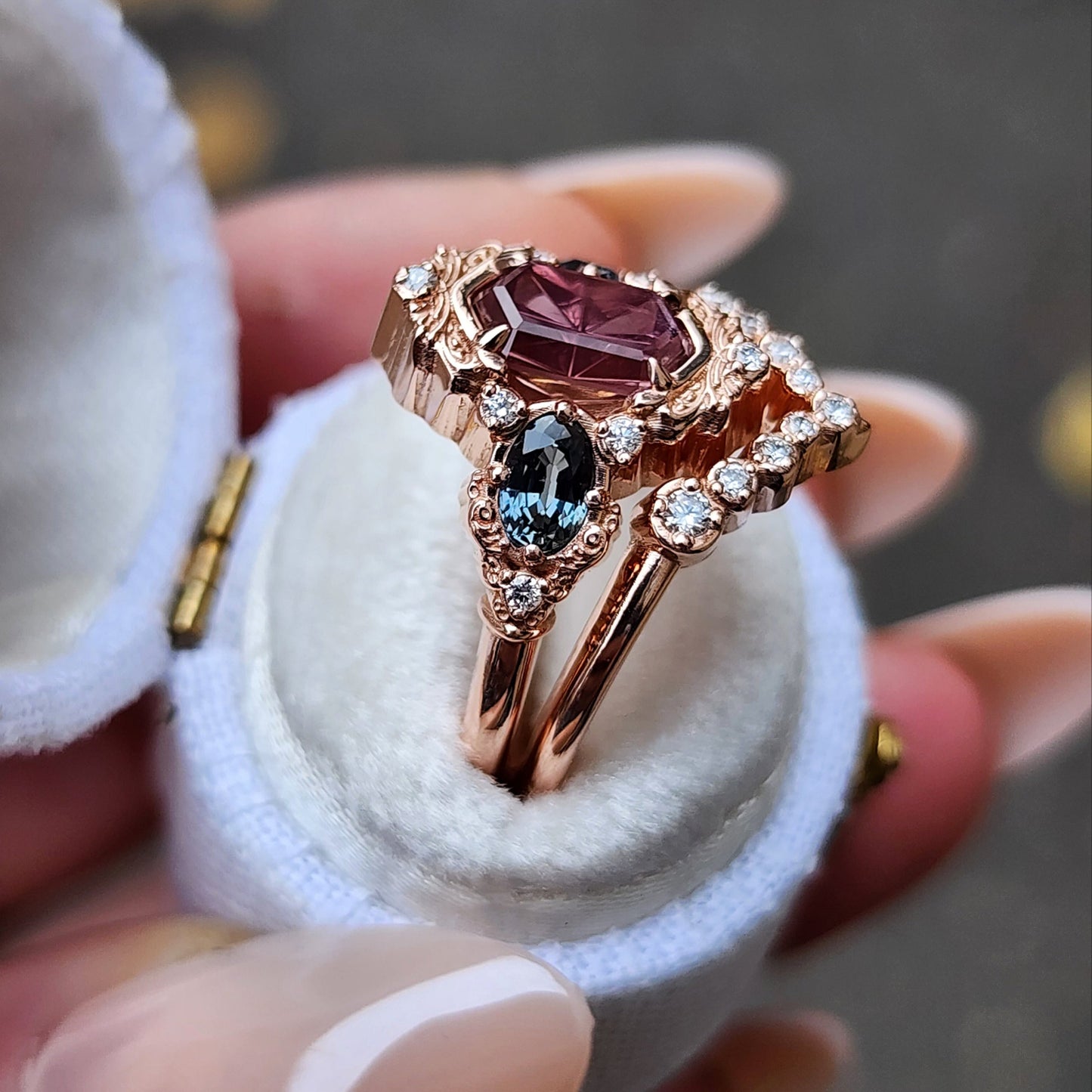 14k rose gold starbrite cut peach umba sapphire hexagon josephine engagement ring with blue sapphire ovals and diamond accents with diamond chevron wedding band fantasy ethereal wedding ring set by swankmetalsmithing