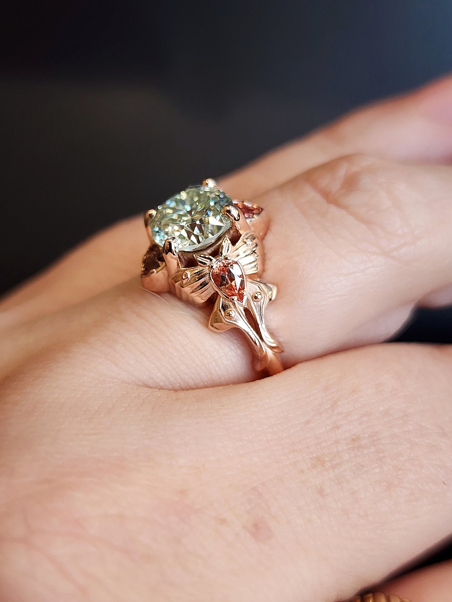 fantasy cut light green round moissanite engagement ring with champagne sapphire pears and trillions gold luna moths 14k fantasy jewelry