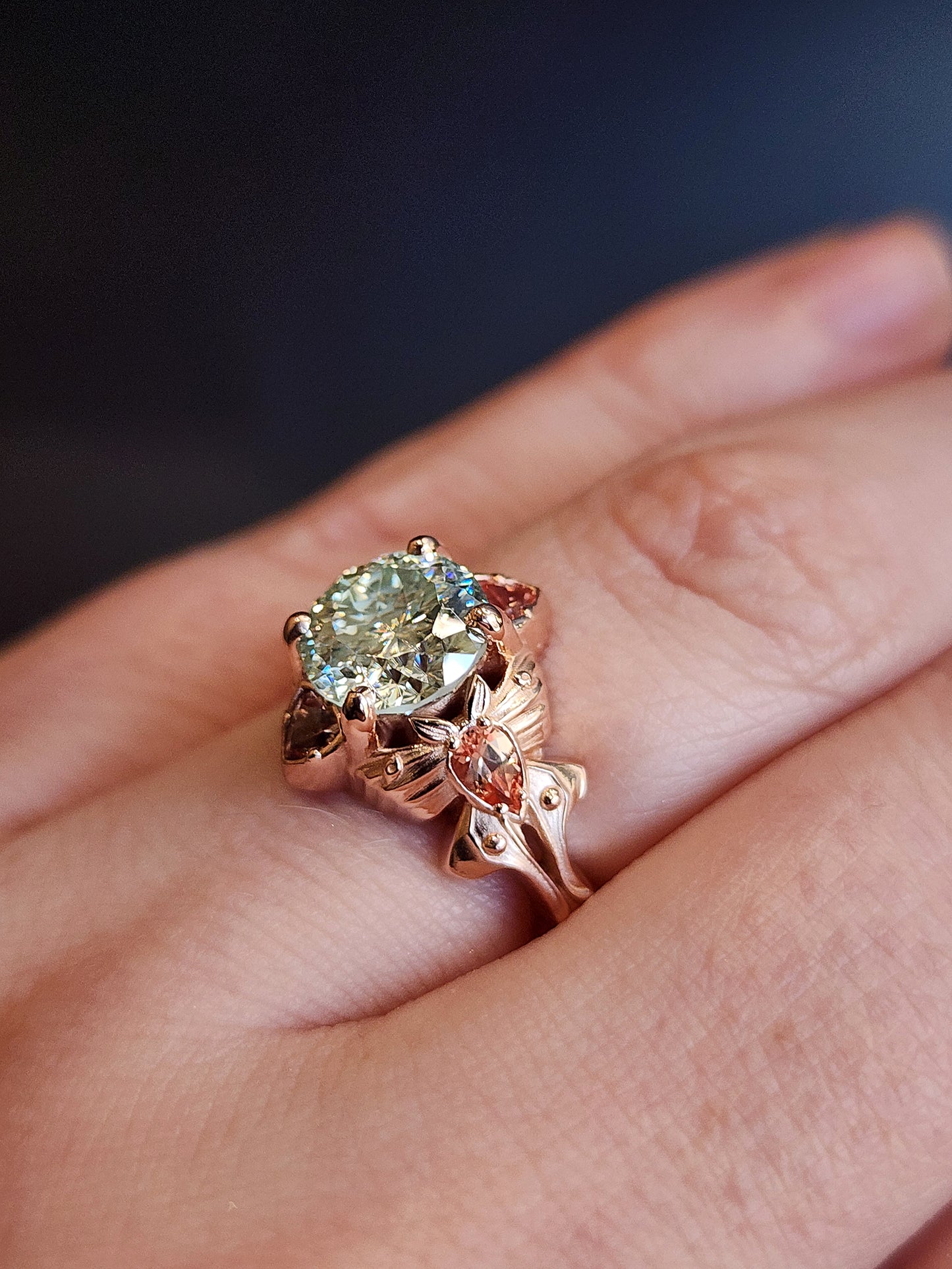 fantasy cut light green round moissanite engagement ring with champagne sapphire pears and trillions gold luna moths 14k fantasy jewelry