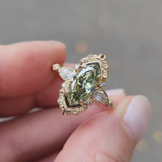 Load and play video in Gallery viewer, Fairy green marquise moissanite engagement ring Odette with gold scroll side band and diamond accents 14k yellow gold vintage inspired artisan fine jewelry made in portland oregon
