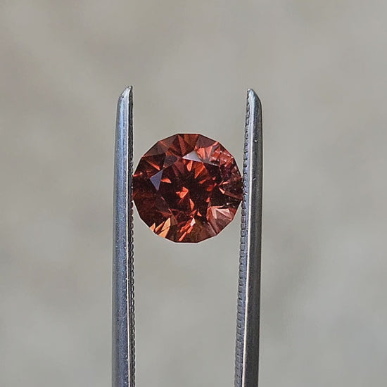 Load and play video in Gallery viewer, 1.41ct Natural Round Cut Malaya Mahenge Garnet

