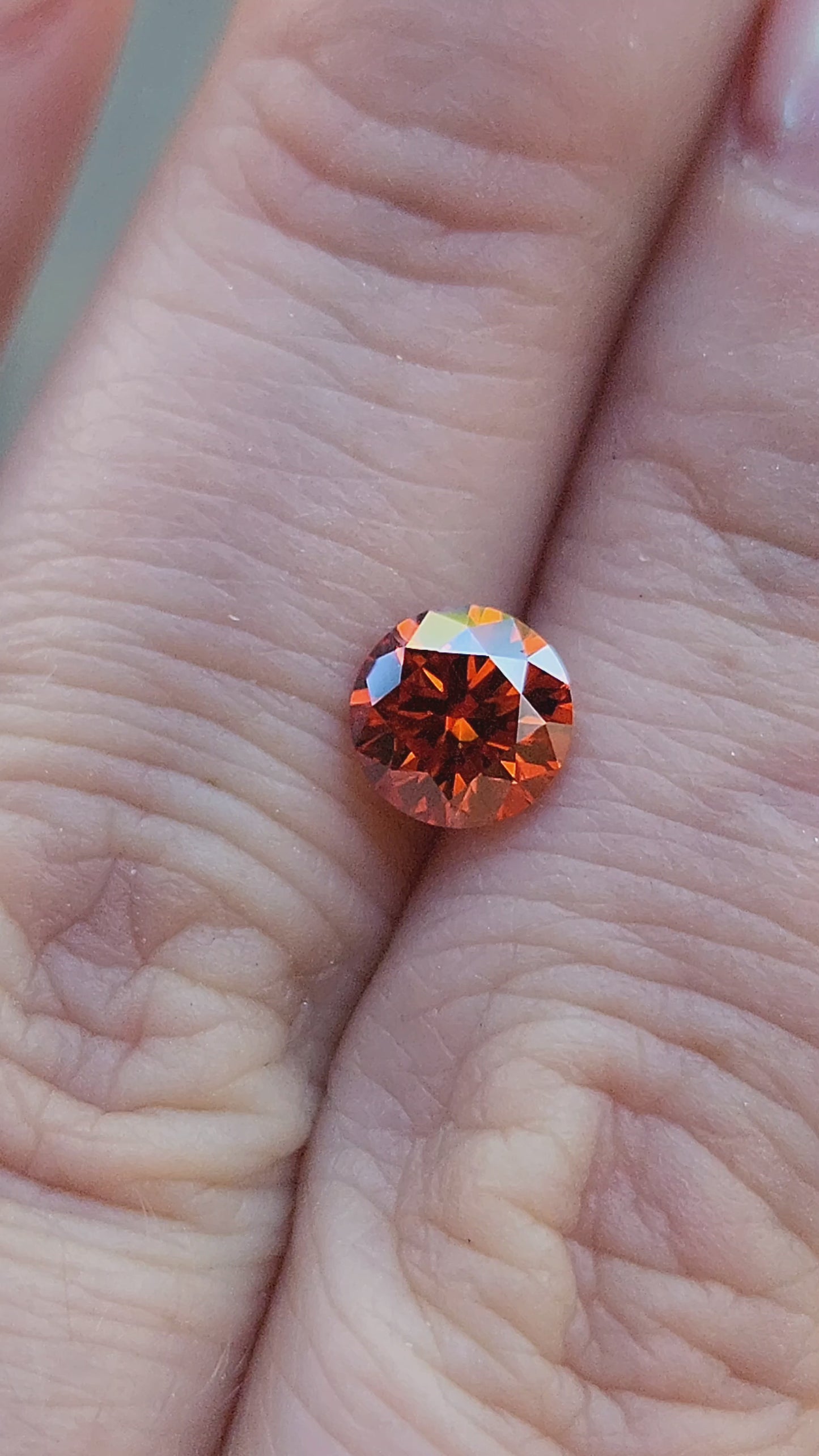 Load and play video in Gallery viewer, .95ct Round Orange Moissanite 6.4mm

