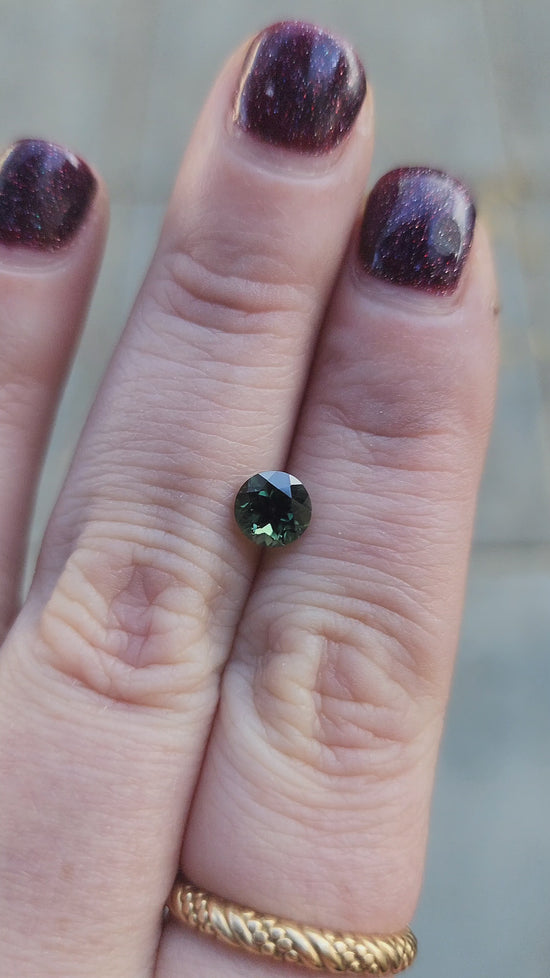 Load and play video in Gallery viewer, 1.13ct forest green australian sapphire round brilliant 
