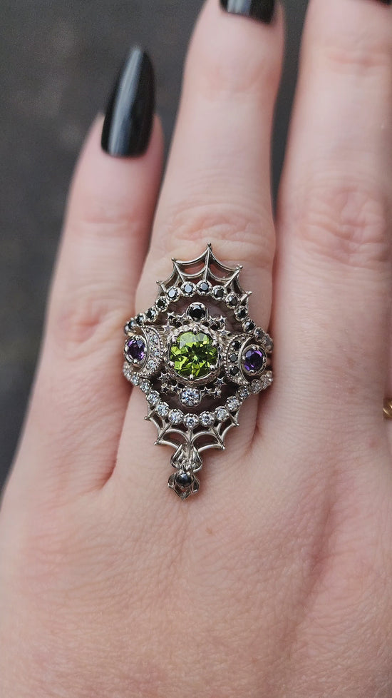 Load and play video in Gallery viewer, peridot and amethyst cosmos ring with black and white diamond spider web wedding bands goth pop culture wedding ring
