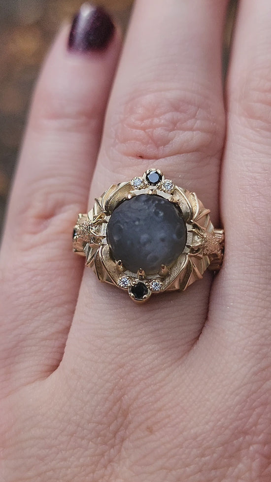 Load and play video in Gallery viewer, Keepers of the Moon ring by SwankMetalsmithing with hand carved gray moonstone moon and gold vampire bats
