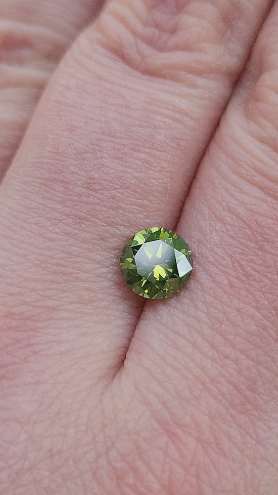 Load and play video in Gallery viewer, 1.34ct Irradiated Natural Green Round Brilliant Diamond
